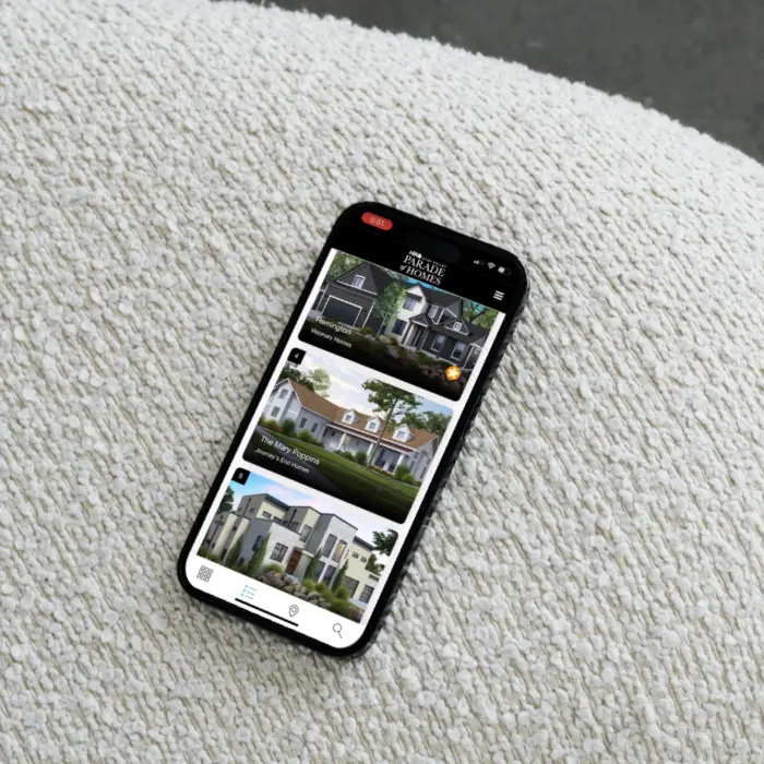 phone using the paradesmart app showing home listings