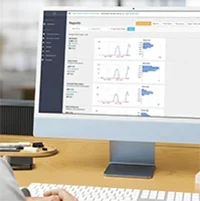 A ParadeSmart reporting dashboard with demographic charts shown on a desktop monitor