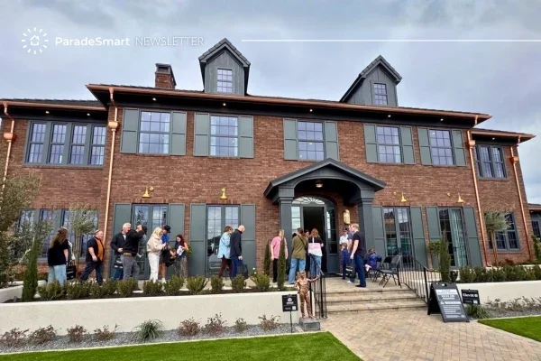 Visitors touring a large brick Parade of Homes show home during an open house