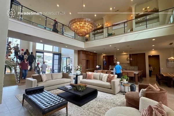 Visitors touring the open, sunlit foyer of a Parade of Homes show home